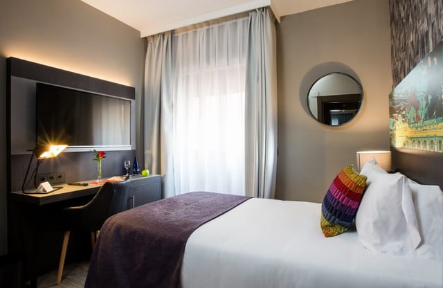 Modern hotel room in Leonardo Boutique Madrid with workspace for business travel and accommodation.