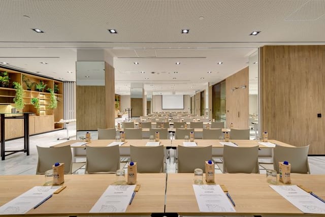 Modern Hotel Serrano conference room, classroom-style setup for corporate workshops and training.