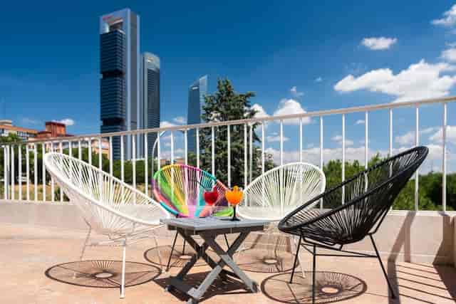 Networking cocktail reception at Madrid Chamartín hotel with urban skyline view.