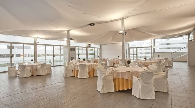 Modern banquet hall with floor-to-ceiling windows for corporate events and wedding venues.