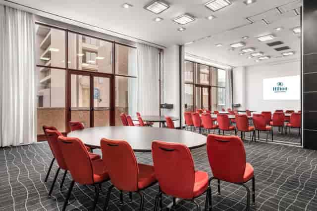 Hilton Madrid Airport meeting space with floor-to-ceiling windows for conferences and workshops.