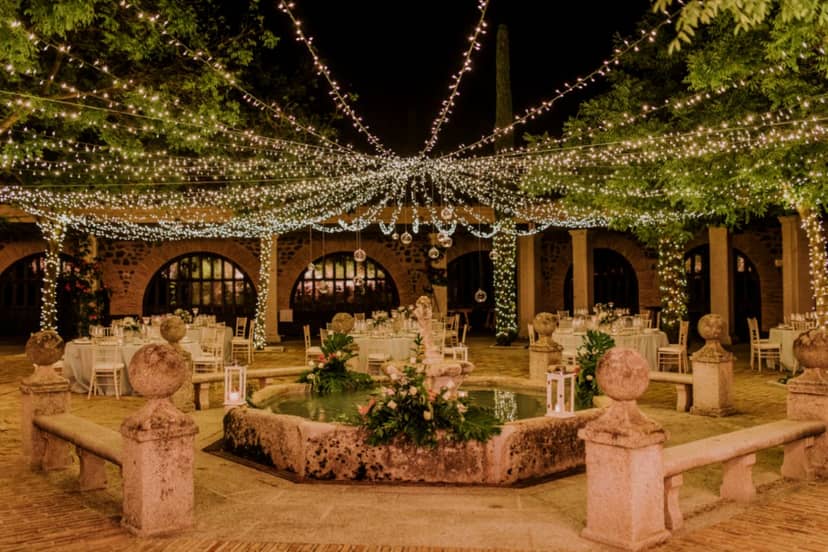 Romantic stone courtyard at Jardín de Agalén with string lights for luxury wedding venue events.