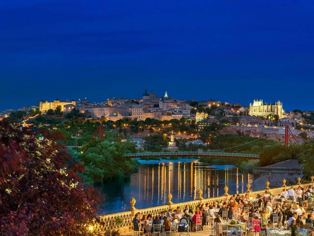 Luxury outdoor gala dinner at Cigarral del Ángel with iconic city skyline for corporate events.