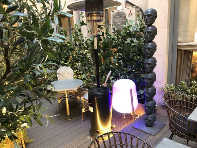 Eclectic sculpture at Club Monteverdi networking event, outdoor exhibition space with mood lighting.