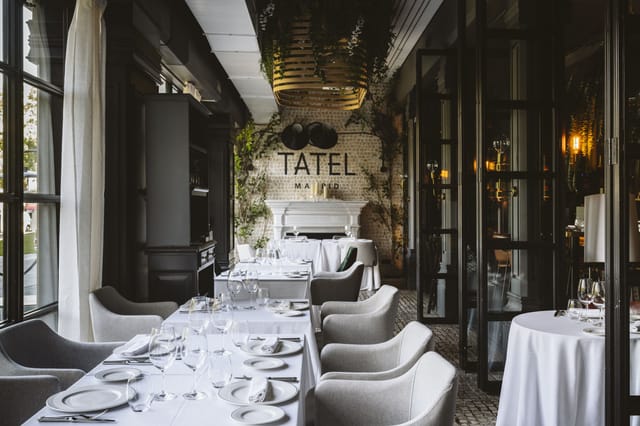 Tatel restaurant bar with white-linen decor for upscale corporate events and private dining.