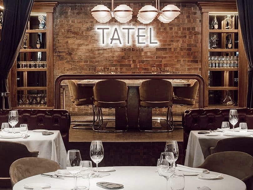 Tatel bar with neon signage, perfect for executive dinners and corporate events.