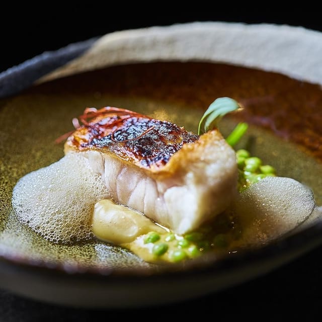 Refined plated main course at Smoked Room Madrid for executive board dinners and VIP galas.
