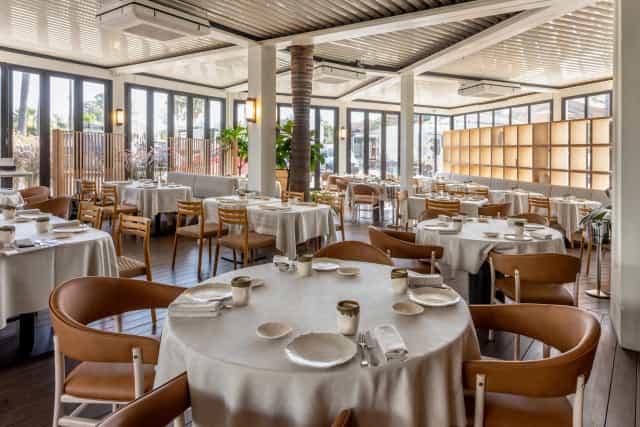 Grupo Dani García bright banquet hall with circular tables for corporate lunches or social events.