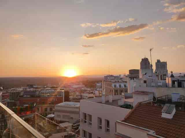 Rooftop venue at golden hour for VIP cocktail reception and networking event.