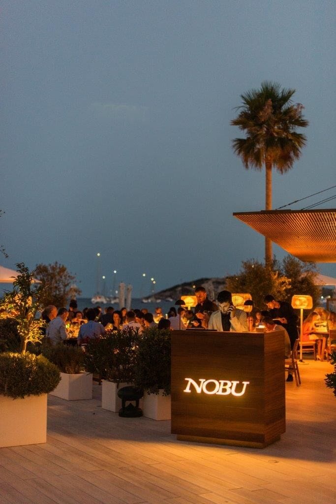 Nobu Rooftop outdoor evening reception with atmospheric lighting for high-end corporate events.