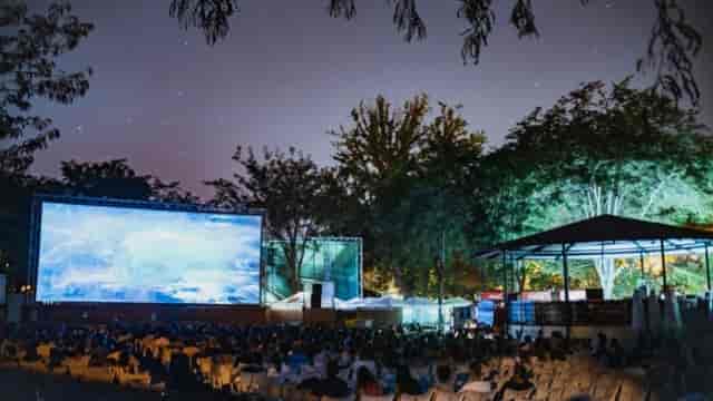 Outdoor cinema at Plaza de España featuring large screen for experiential event and movie night.