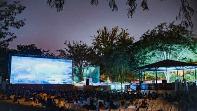 Outdoor cinema at Plaza de España featuring large screen for experiential event and movie night.