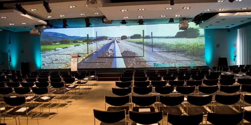 Corporate conference room at UZalacaín La Finca with LED backdrop for professional events.