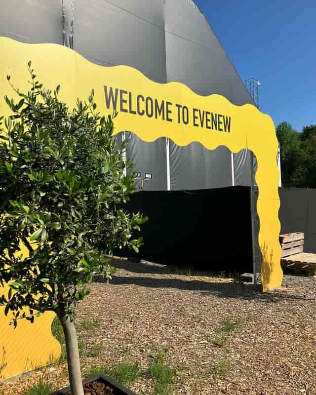 Branded archway at E V E N E W outdoor industrial event venue for festival and brand activation.