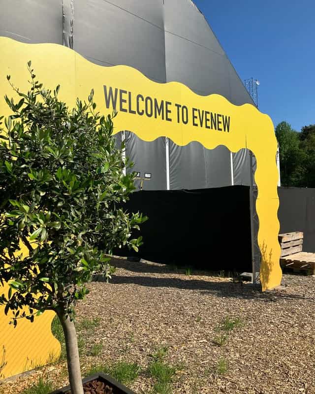 Branded archway at E V E N E W outdoor industrial event venue for festival and brand activation.