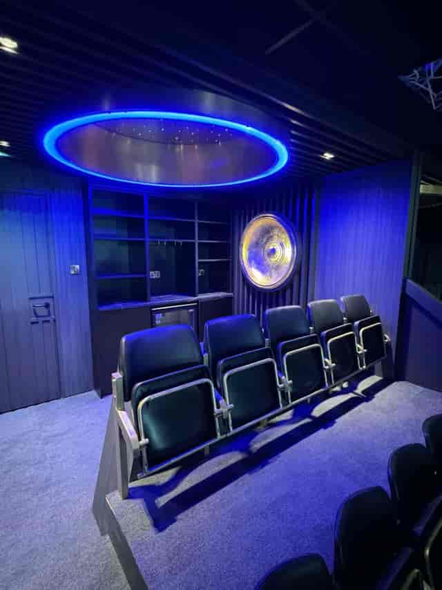 Utilita Arena intimate VIP screening room with theater seating for corporate presentations.