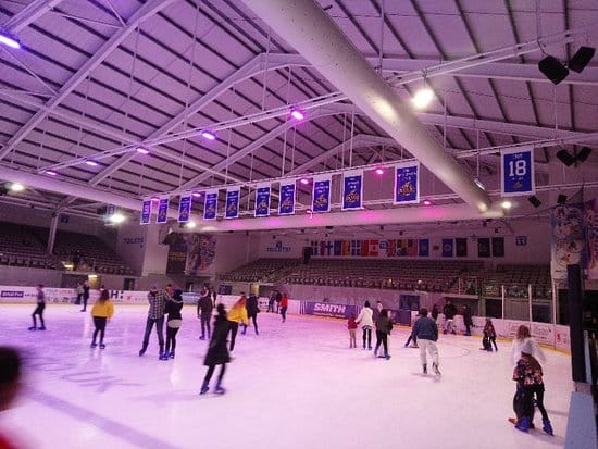 Purple uplighting at Planet Ice rink for corporate team building event.