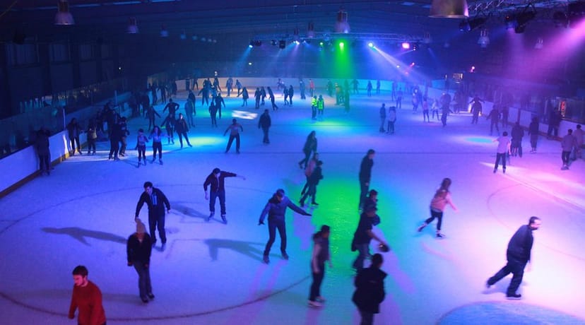 Corporate team building event at an illuminated ice rink for experiential company offsite.