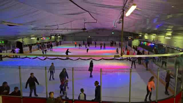 Planet Ice rink with dynamic lighting for corporate team building and ice skating events.