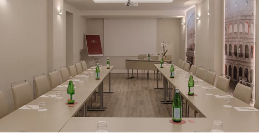 U-shape meeting room with projection screen at NH Collection Roma for corporate business events.