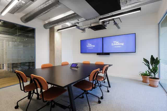Modern Ackerley Meeting Room with large table, ideal for brainstorming and strategy sessions.