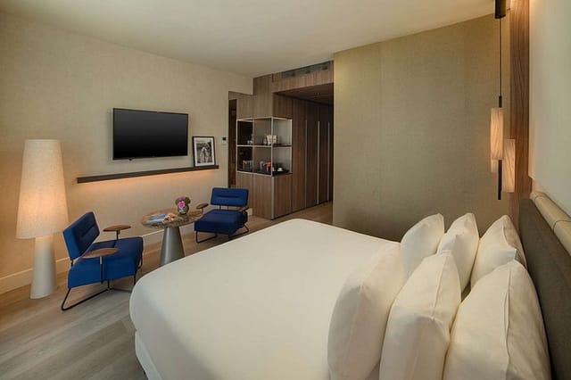 Modern NH Collection Milano CityLife executive suite for conference speaker accommodation.