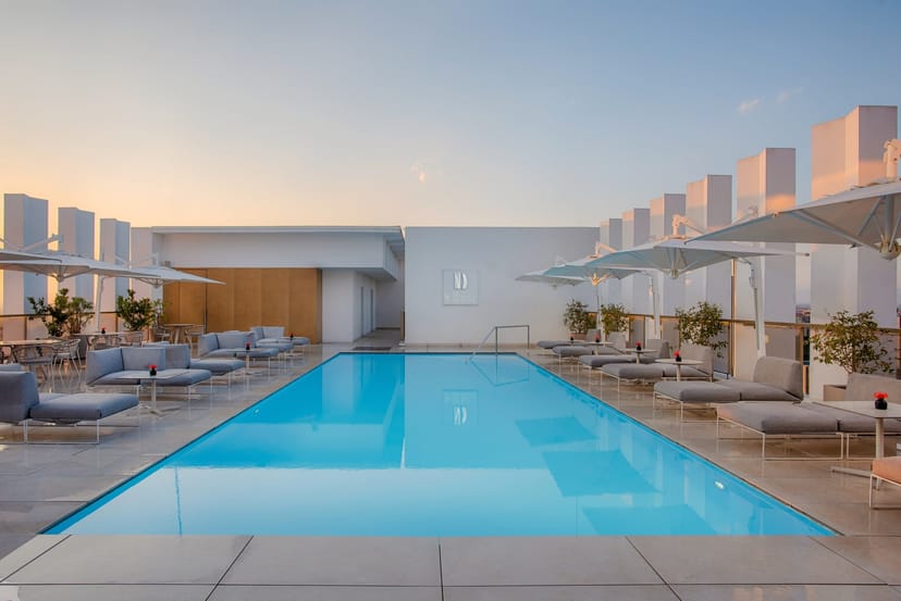 Modern rooftop restaurant with poolside seating for corporate cocktail and networking events.
