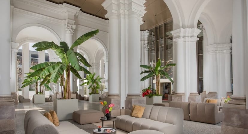 Luxury rooftop pool event space in Milan with soaring columns for networking and corporate events.