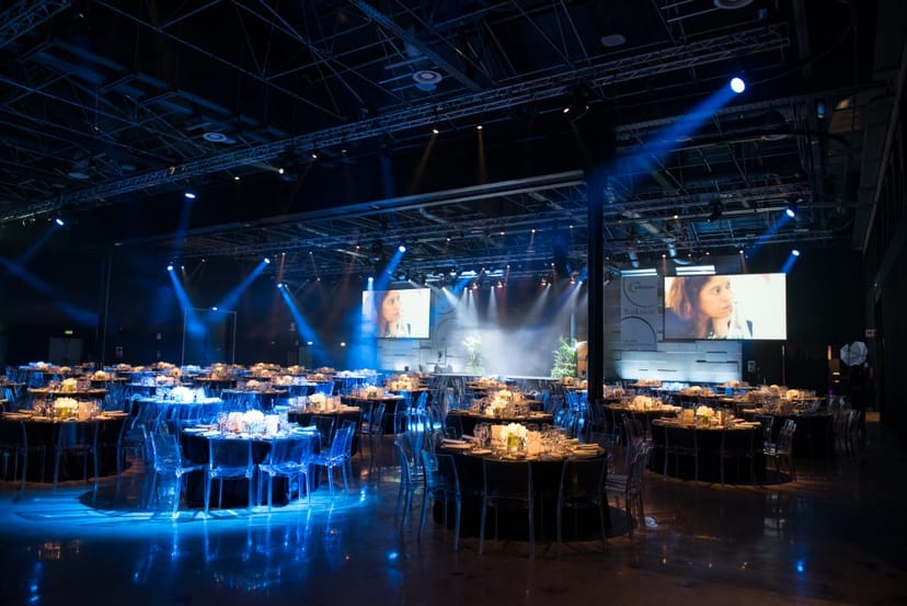 Grand Milan Mecenate gala hall with blue stage lighting for corporate events and luxury weddings.