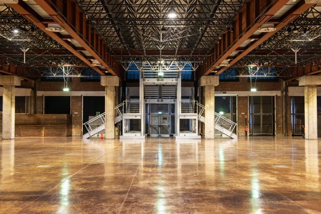 Industrial-chic banquet hall with high ceilings for brand activations and trade shows.