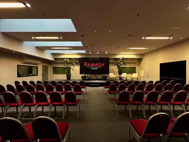 Spazio Cairoli theater-style meeting space with stage for corporate panels and keynote events.