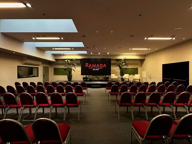 Spazio Cairoli theater-style meeting space with stage for corporate panels and keynote events.