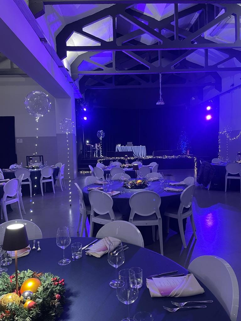 Spazio Cairoli foyer with blue gala lighting and LED centerpieces for corporate dinner events.