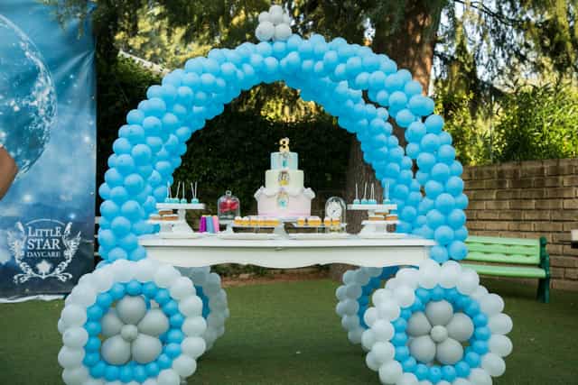 Baby shower dessert station with whimsical balloon carriage at Luna Di Vanna outdoor event.