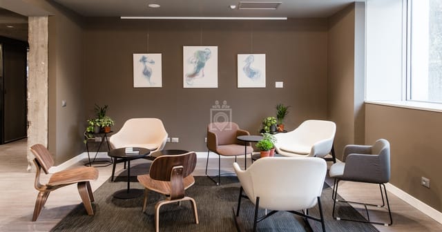 Virtual office breakout space with flexible seating for professional meetings and coworking.