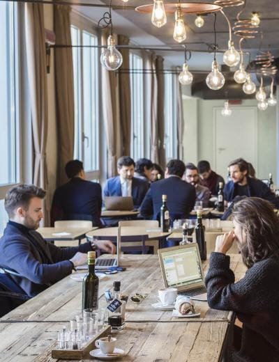 Modern coworking space at Copernico Centrale for flexible office off-site events.