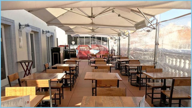 Taberna Puertalsol wooden bistro tables for outdoor corporate events or private networking.