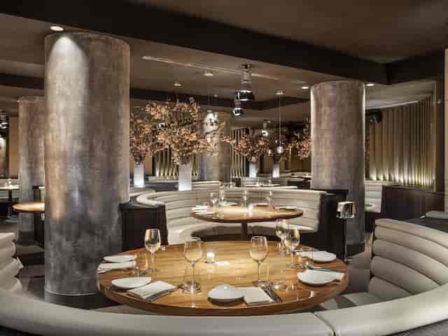 Upscale indoor lounge with semi-circular booths for VIP dinners and boutique networking events.