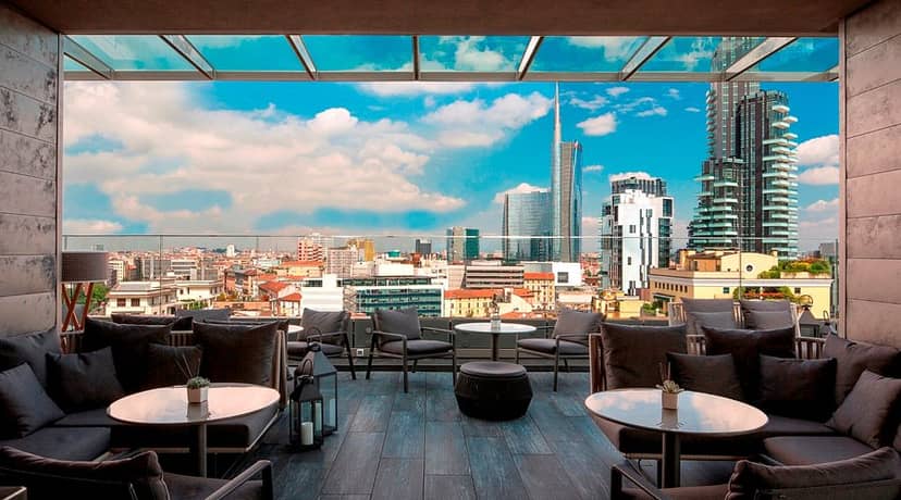 ME Milan Il Duca rooftop lounge with skyline view for corporate events and VIP networking.