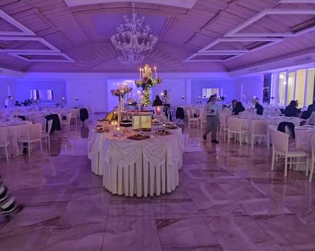 Sala Giardini ballroom with purple lighting and buffet stations for a formal gala or wedding.