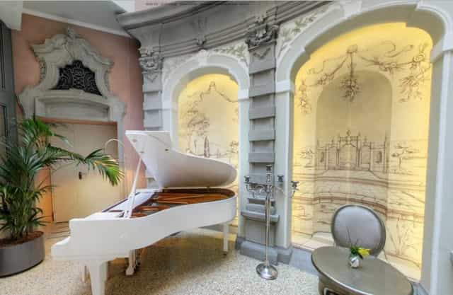 White grand piano in Sala del Rubacuori, ideal for VIP cocktail hours and upscale networking events.