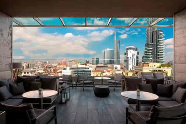 STK Milan rooftop cocktail bar with skyline view for upscale networking and VIP event reception.