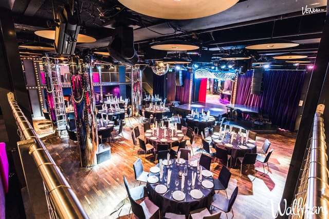Multi-level dance hall with stage lighting for awards dinner and corporate gala events.