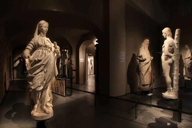 Historic Duomo Museum architecture with atmospheric lighting for exclusive evening receptions.