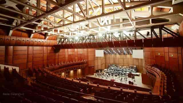 M.A.C. Milan auditorium with wood paneling, ideal for professional conferences and keynotes.