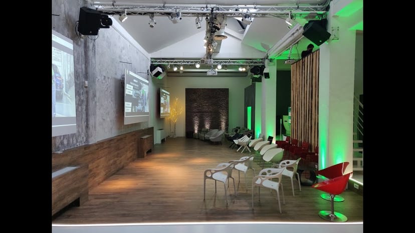 Industrial-chic event space with exposed trussing for corporate workshops and brand activations.