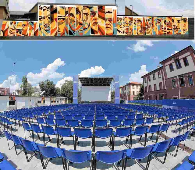 Outdoor theater plenary setup with mural backdrop at Arena Milano Est for corporate events.