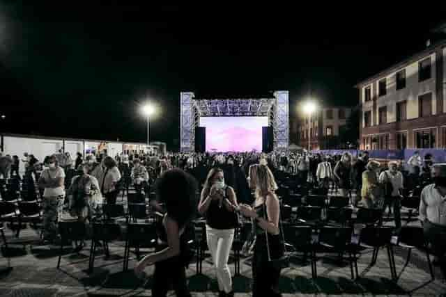 Outdoor movie theater at Arena Milano Est with professional stage screen and seating.