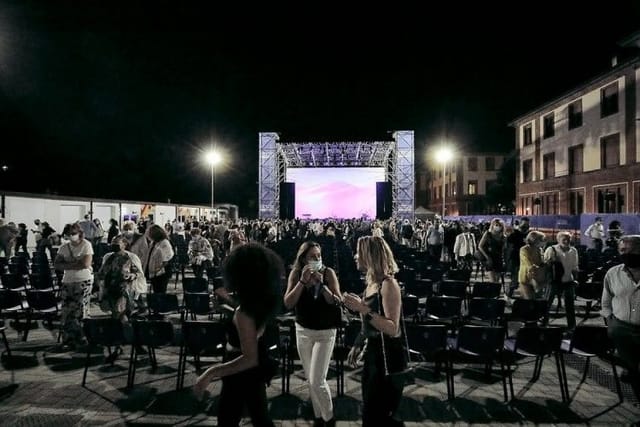 Outdoor movie theater at Arena Milano Est with professional stage screen and seating.