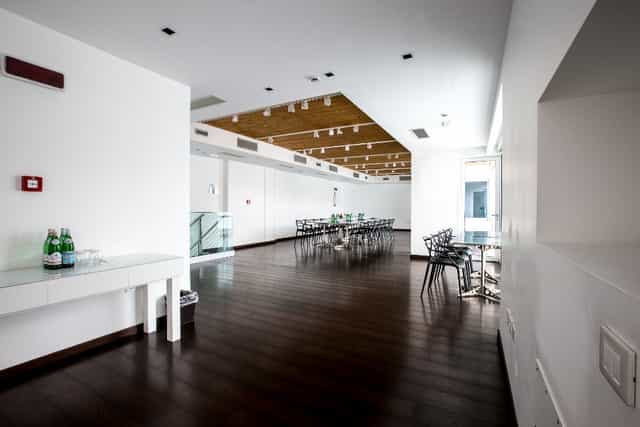 Minimalist roof deck boardroom, industrial event space for corporate meetings and workshops.